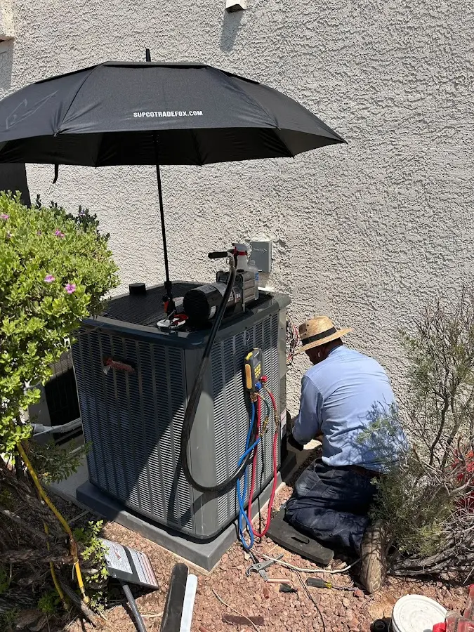 HVAC technician performing outdoor AC maintenance in Palm Springs North